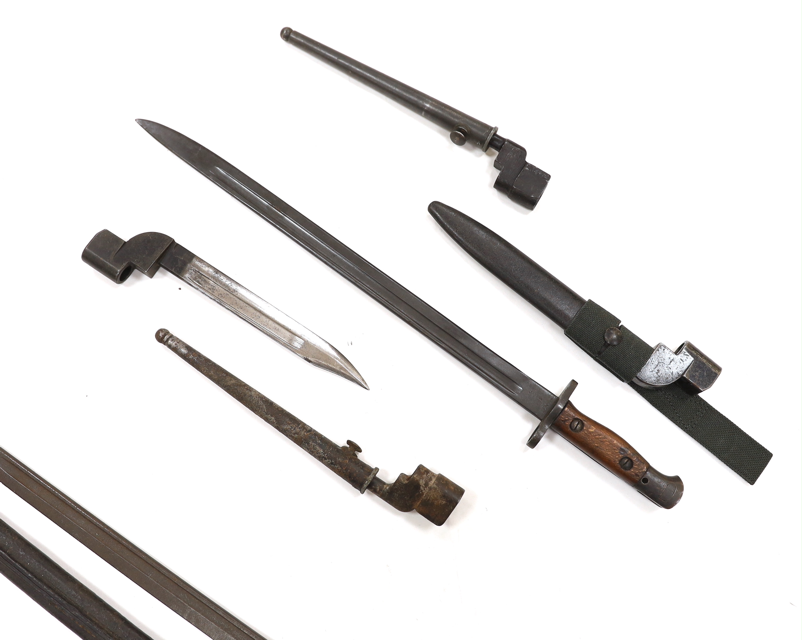 Six bayonets; an American Remington bayonet dated 1917 in its leather scabbard, a British 1907 bayonet with scabbard missing, and four assorted spike bayonets